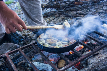 Roasting fish on a campfire