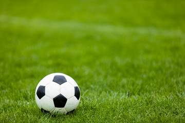 Soccer Football Ball on Soccer Field. Green Grass Soccer Pitch