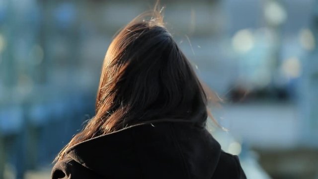 Portrait of happy and enthusiastic young 30 year old woman smiling and waving to camera. Girl teasing viewer