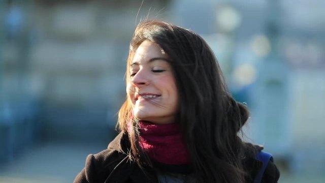 Portrait of happy and enthusiastic young 30 year old woman smiling to camera