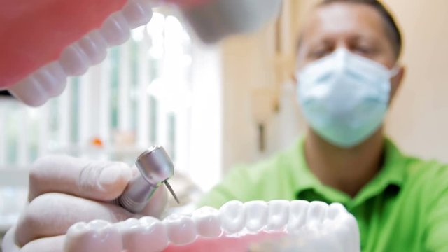 Closeup 4k footage from inside of mouth of dentist treating teeth with drill
