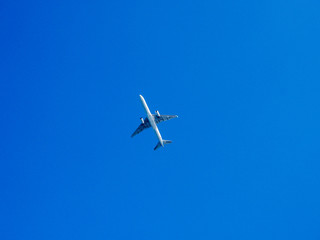 silhouette of airplane flying over the blue skies