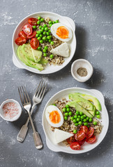 Savory  breakfast grain bowl. Balanced buddha bowl with quinoa, egg, avocado, tomato, green pea. Healthy diet food concept. Top view, flat lay