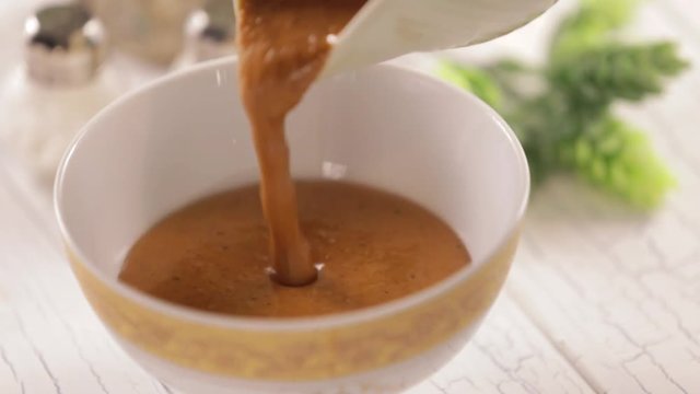 Pouring gravy in small bowl