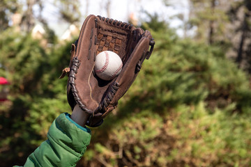 Fototapeta premium Children hand with baseglove holding baseball ball