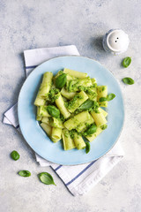 Rigatoni pasta with basil pesto.Top view.