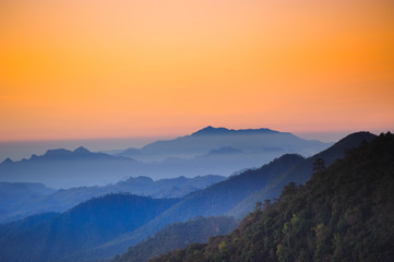 Naklejka na ściany i meble Beautiful mountains with shades of orange scenery in the early morning dawn.