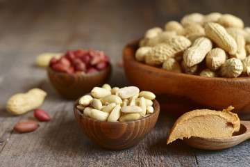 Obraz na płótnie Canvas Assortment of peanut in a wooden bowls and peanut butter.