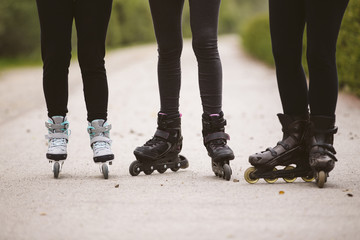 Close-up view of group of female legs on roller skates