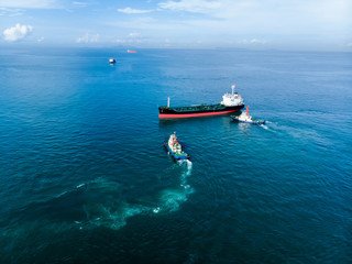 Gas ship and pilot ship navigate to dock yard port.