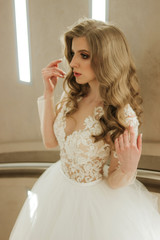 Beautiful bride with fashion wedding hairstyle. Bride at wedding in white wedding dress and veil. Luxurious wedding.