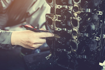 technician working on checking and service car in  workshop garage; technician repair and maintenance engine of automobile in car service