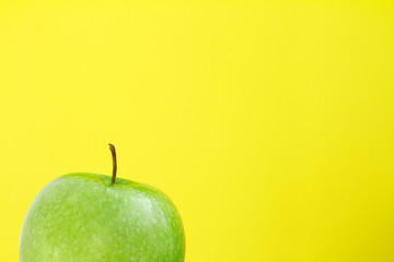 part of green Apple on yellow background