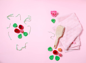 
Rose flower shapped soap and pink bath towel with body cleaning brush on pink background, top view, overhead, copy space