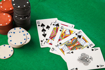 Poker chips and cards on green table