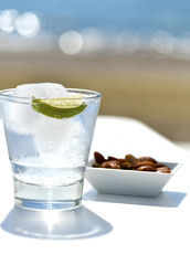 Image of cool ice drink on a beach, with the sea and sand in the background tapas snack , selective focus, on a white foreground, shot for copy space printed on Printed Glass Basin Splashbacks