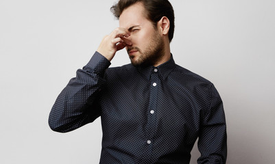 Fototapeta premium Handsome bearded casual man standing isolated on a white empty background and looking away.