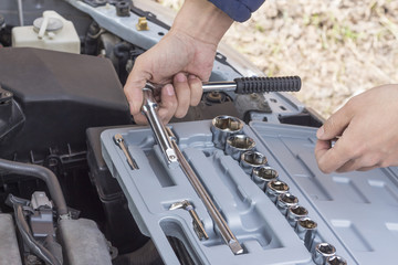 Fototapeta premium Auto mechanic with working tools For repair and diagnostics of cars. Concept auto repair