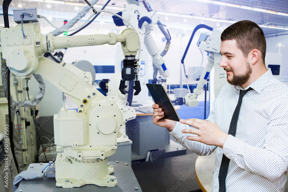 Aufkleber Engineer with tablet. Programming robot with robotic arm. Smart factory 