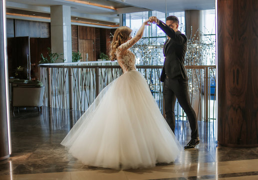 A Young Couple Is Dancing At A Ball. Ballroom Dance. Romantic Couple Of Newlyweds First Elegant Dance At Wedding.