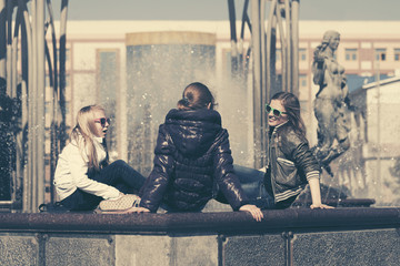 Group of happy teen girls talking in city street