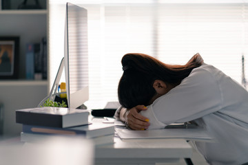 Businesswoman she was lying on the table, she was tired of working in the office.