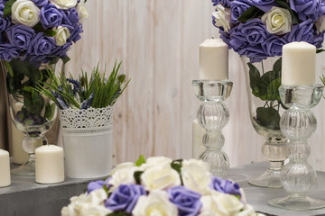artificial flowers in vase and candlesticks in candlesticks for romantic atmosphere