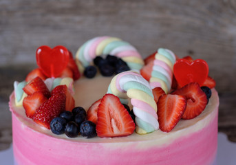 beautiful home made pink purple cake and cupcakes