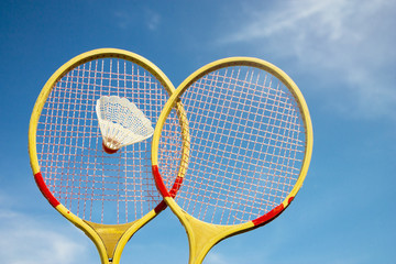 Two badminton rackets and shuttlecock flying