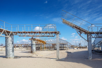 Sea sand beach with abandoned constructions 
