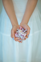 woman hands holding some vintage candy, sensual rural studio shot can be used as background