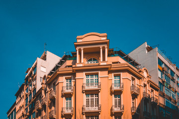 Fototapeta na wymiar orange corner building with darken blue sky