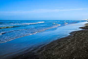 Fototapeta na wymiar Black sand beach in Ladispoli, Italy