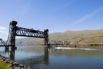 Bridge over the Clearwater river, Lewiston Idaho on a sunny day with motor boat 