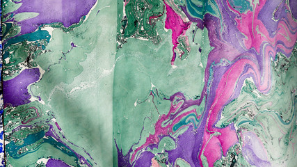 Decorative marbled paper in purple, pink and green