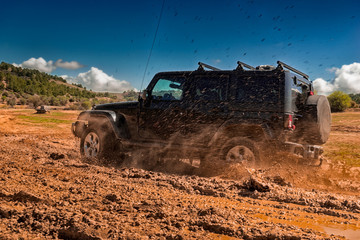 All-terrain vehicle passing through an area of mud © cineuno