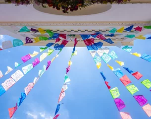 Fototapeten Colorful prayer flags hanging on San Lorenzo church, Zinacantan, Chiapas, Mexico   © SimoneGilioli