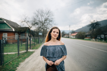 Girl in a dress on a background of mountains