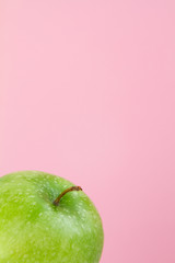 part of green Apple on pink background
