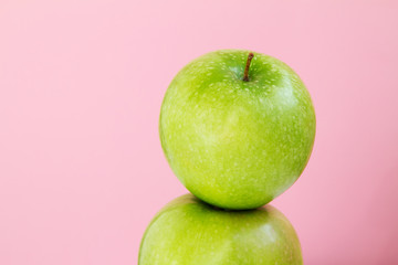 part of green Apple on pink background