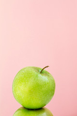 part of green Apple on pink background