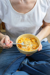 corn flakes in a bowl in hands