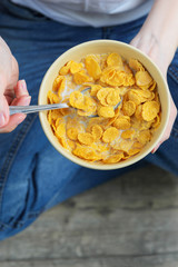 man holding a bowl of cornflakes