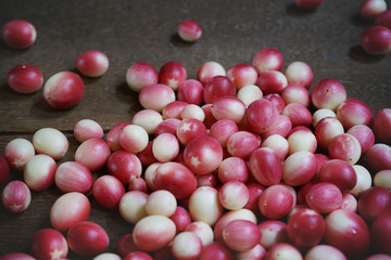 Close up fruit Carissa karanda Lin on old wood.