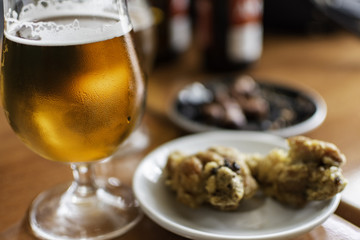 Beer glass with tapas food.