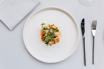 Modern French cuisine: Top view of lobster tail salad including lobster, asparagus and roasted sunflower seeds with white sauce served in white plate.