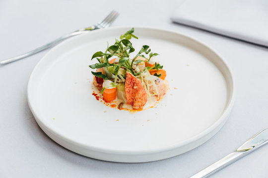 Modern French Cuisine: Lobster Tail Salad Including Lobster, Asparagus And Roasted Sunflower Seeds With White Sauce Served In White Plate.