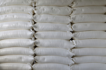 Three piles of big sacks at warehouse in modern factory