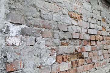 Weathered red brick wall background with spots