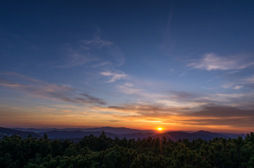 The sun and mountains on the horizon. Twilight in the mountains.